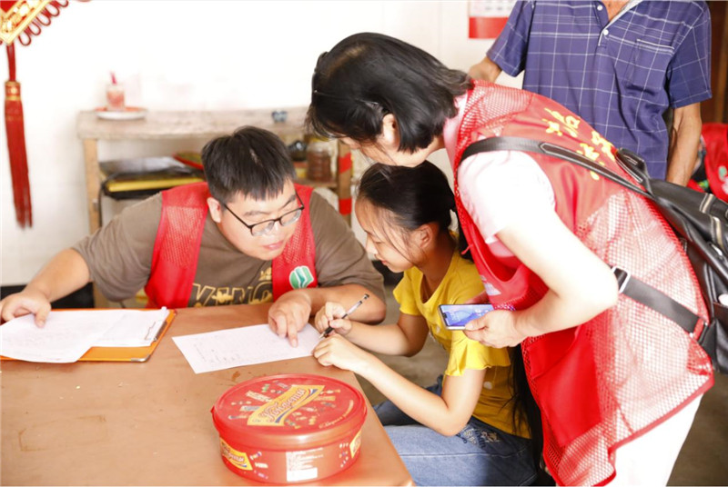 同學(xué)們在志愿者的指導下填寫(xiě)《入戶(hù)調查表》.jpg